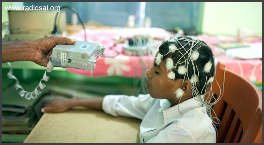 indian boy having EEG tests at Sathya Sai mobile outreach hospital landscape